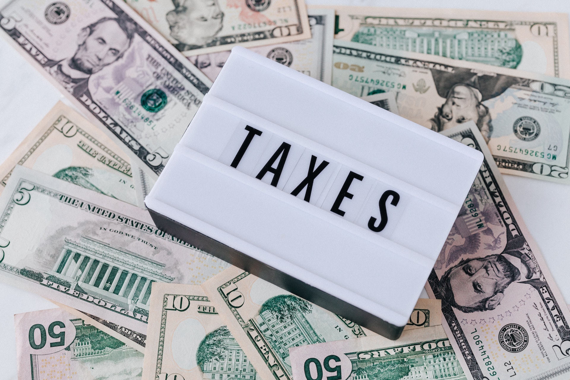 money with "taxes" sign